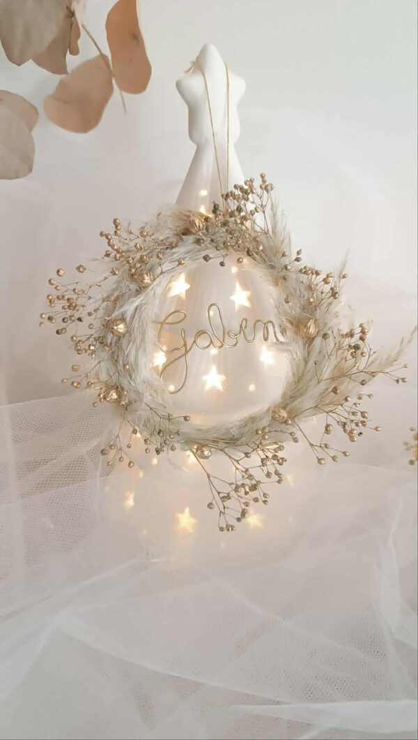 Suspension de Noël artisanale personnalisée en forme de mini couronne, décorée de fleurs séchées de pampas et de boom dorées, avec un prénom en fil doré, faite main, idéale pour décorer le sapin de Noël ou une porte dans un style naturel et poétique. Suspension de noël avec pampa - Ornement sapin de noël chic et bohème à personnaliser - Décoration sapin de noël avec prénom ou mot doux - Idée cadeau à offrir pour noël avec fleurs séchées